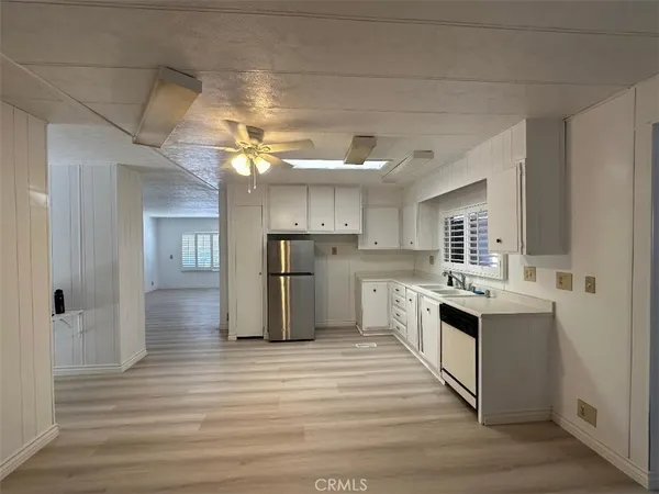a kitchen with cabinets and wooden floor