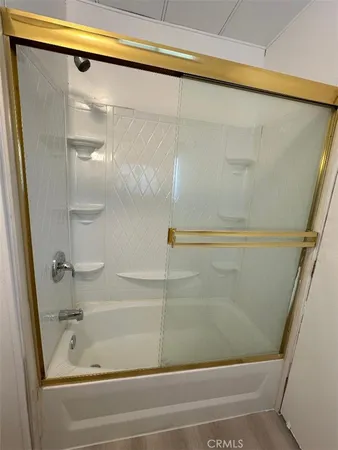 a bathroom with bathtub and shower