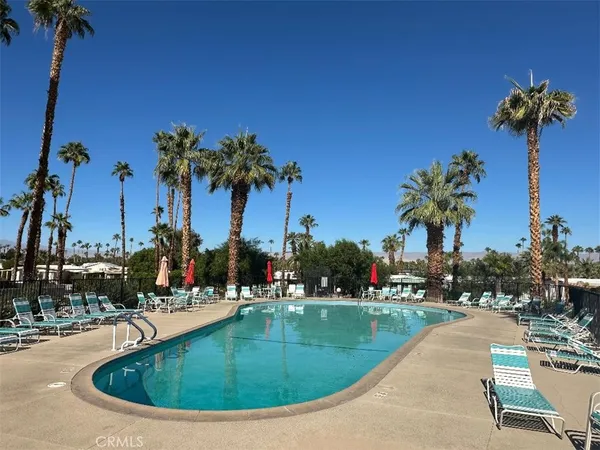 a view of a swimming pool with a table and chairs