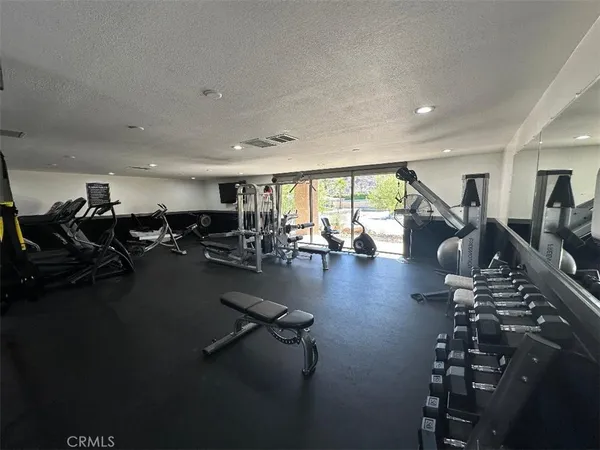 a gym room with lots of gym equipment