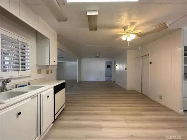 a view of a kitchen with a sink and a window