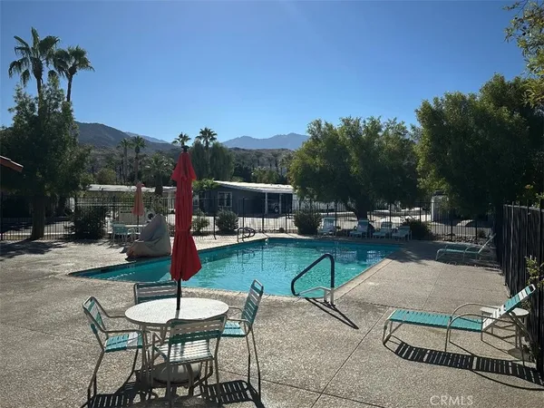 a swimming pool with outdoor seating and yard