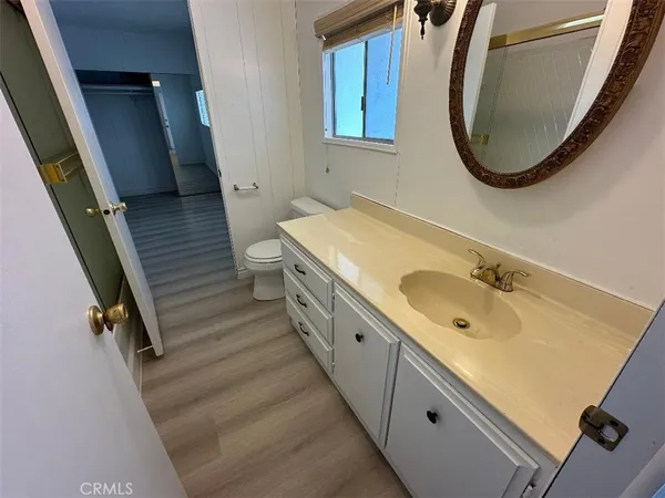 a spacious bathroom with a granite countertop sink and a mirror