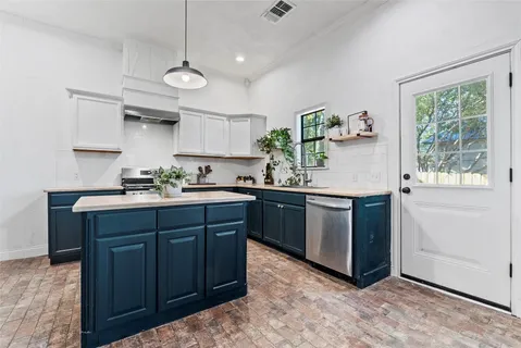 a kitchen with granite countertop wooden cabinets and a sink