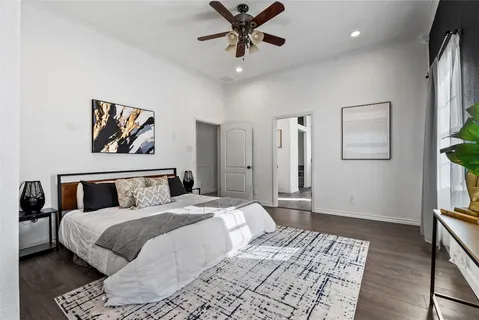 a bedroom with a large bed and a chandelier