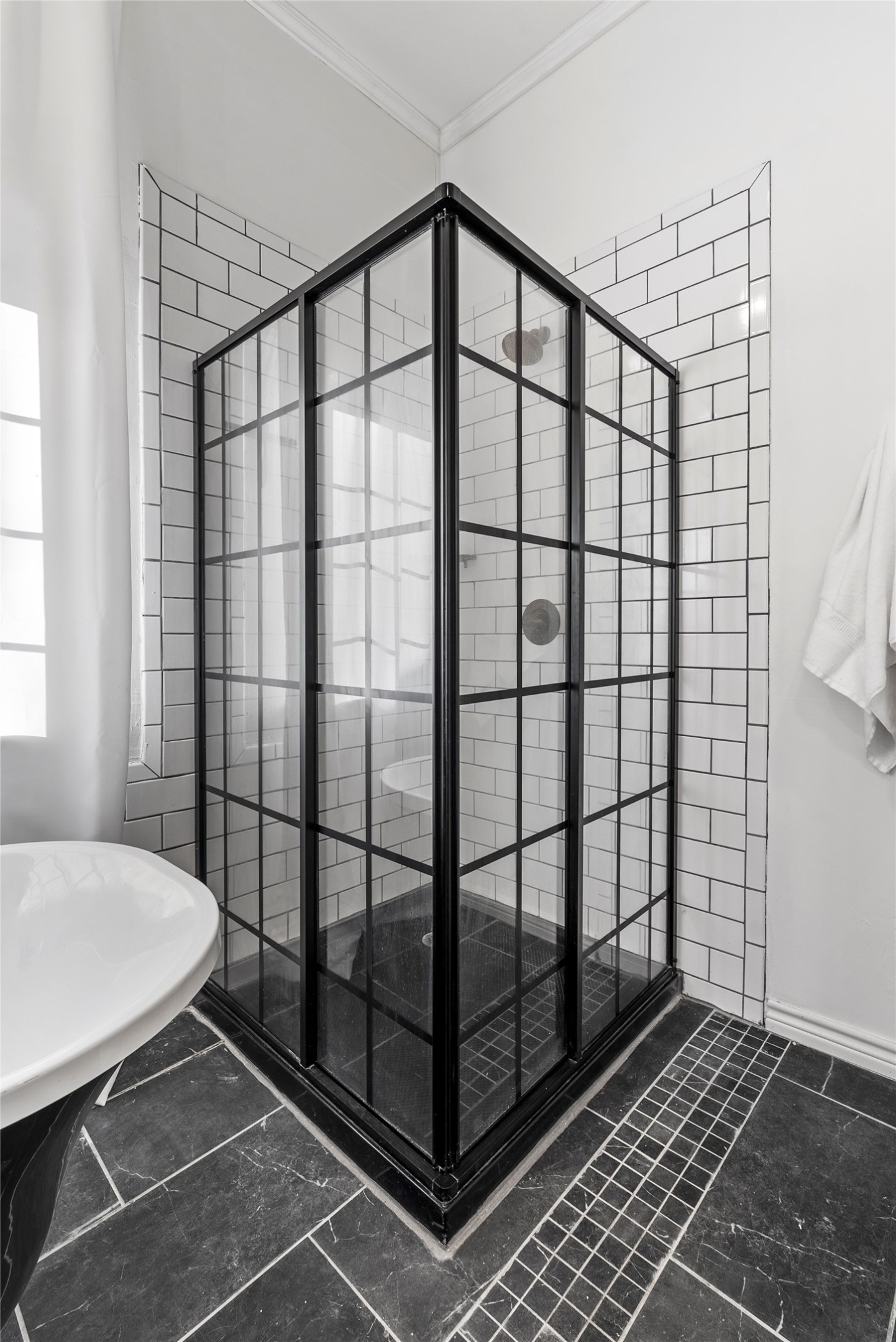 1011 Porter Street Taylor, TX 76574 - Photo 19 of 35 The bathroom's show-stopper is the black matte, grid-pattern glass walk-in shower.