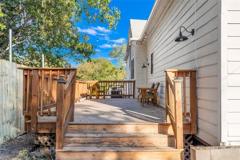 a view of a house with a small yard and wooden fence