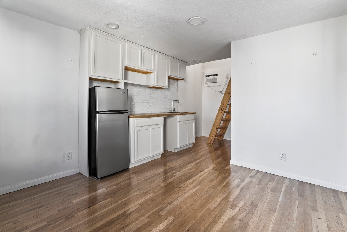 1011 Porter Street Taylor, TX 76574 - Photo 28 of 35 a view of kitchen with wooden floor and electronic appliances