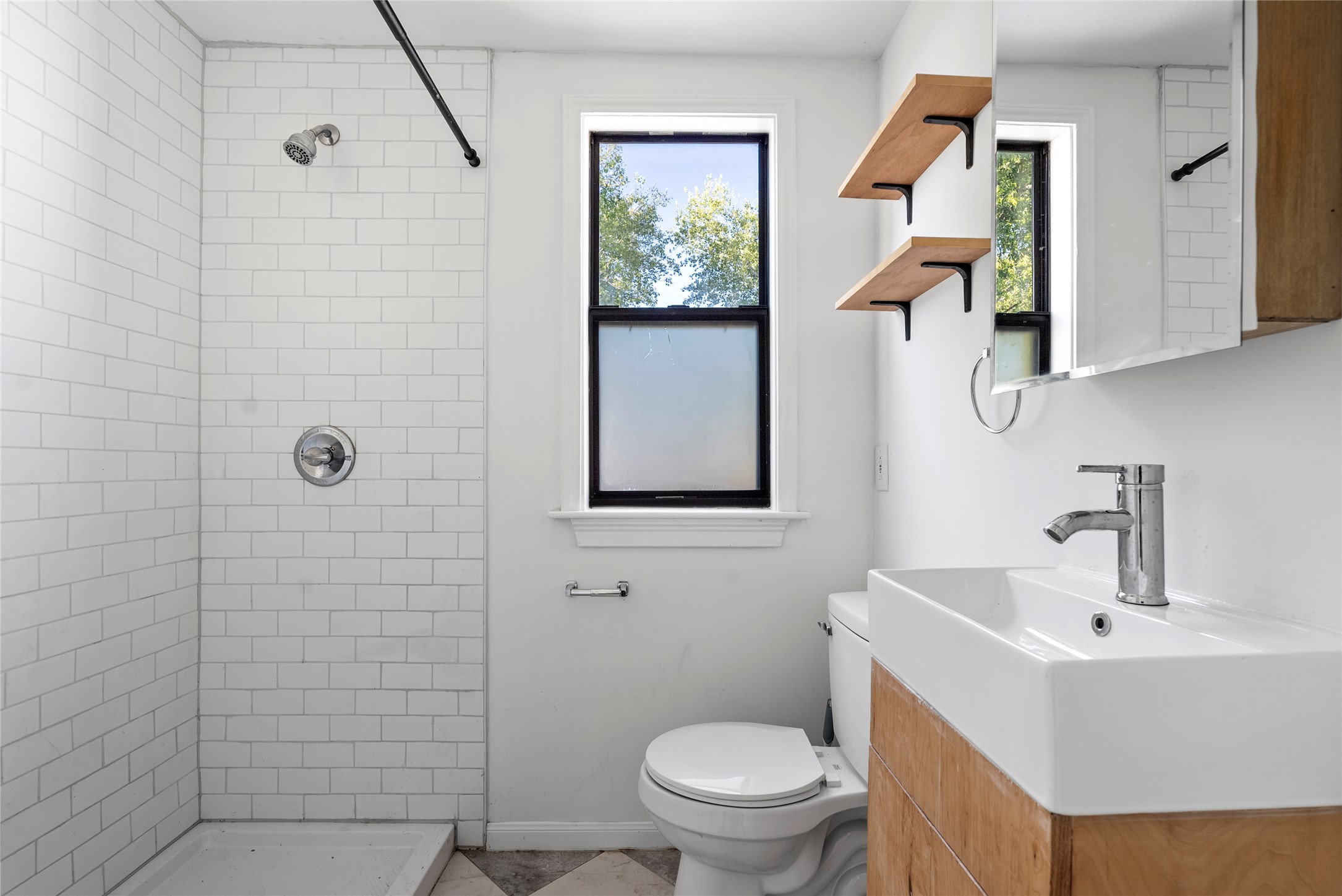 1011 Porter Street Taylor, TX 76574 - Photo 30 of 35 There's a full, updated bathroom with a walk-in shower.