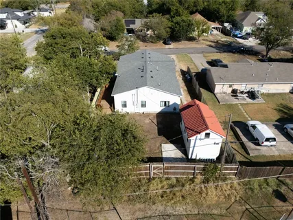 a backyard of a house with table and chairs