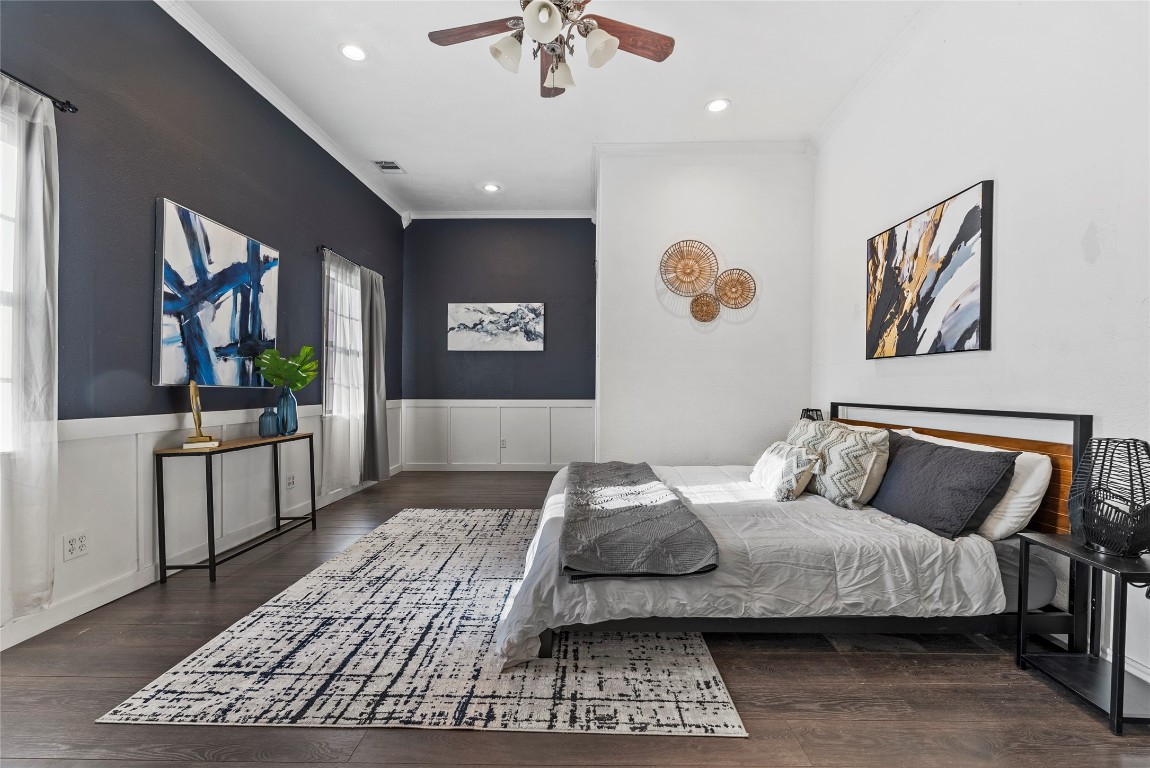 1011 Porter Street Taylor, TX 76574 - Photo 5 of 35 a bedroom with a large bed and a chandelier