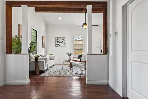 a living room with furniture and a wooden floor