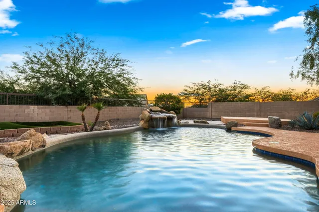 a view of a lake with lawn chairs