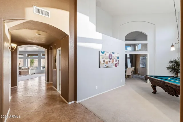 a living room with furniture and dining table