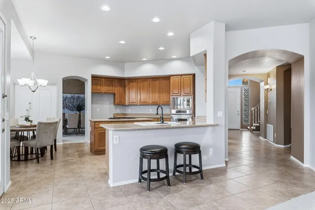 a living room with furniture a fireplace and a large window