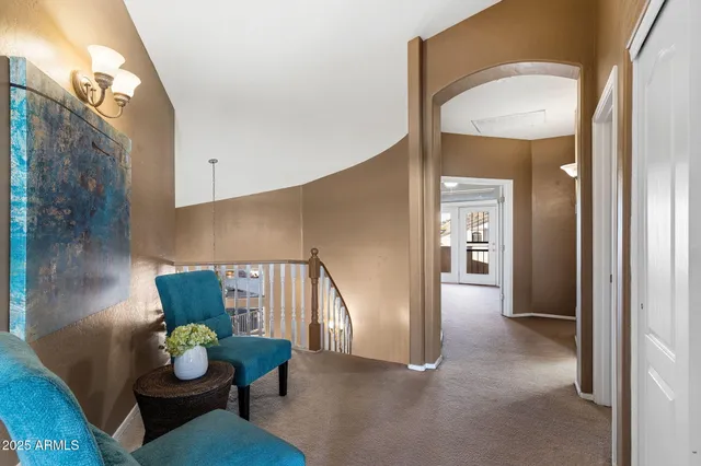 an empty room with windows and ceiling fan