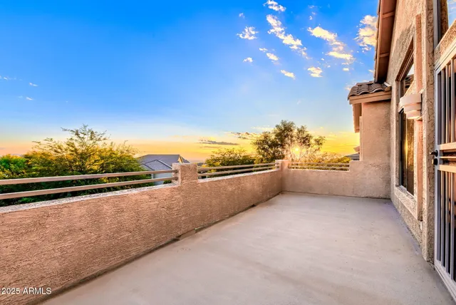 an empty room with windows and ceiling fan