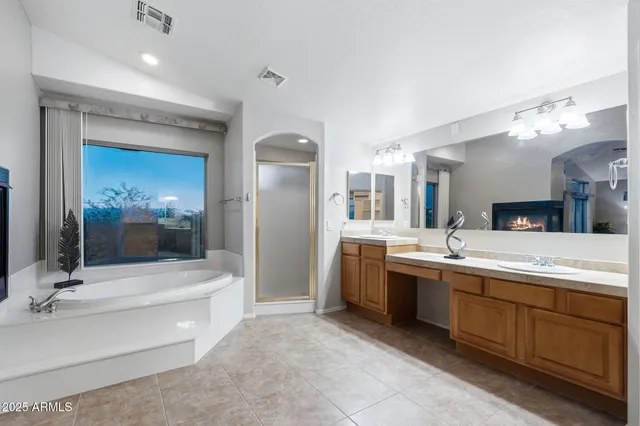 a bathroom with a double vanity sink mirror and toilet
