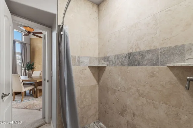 a white house with a tree in the background