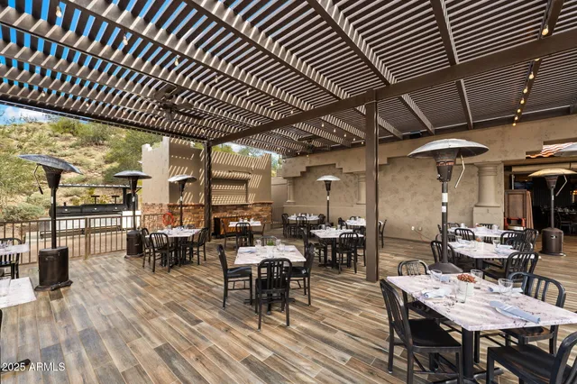 a view of a patio with a table and chairs under an umbrella