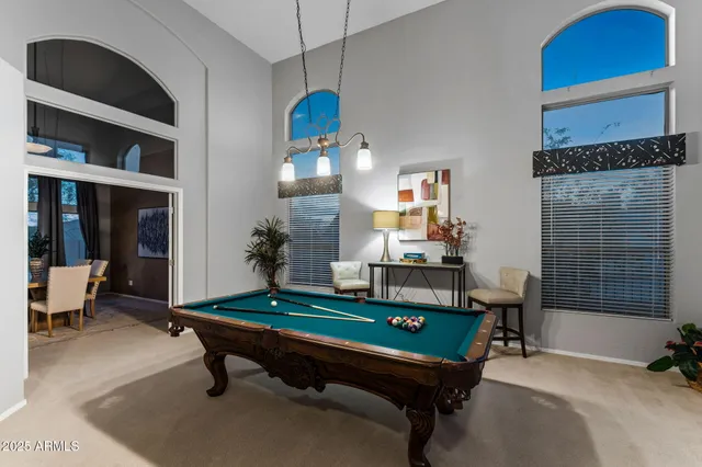 a kitchen with stainless steel appliances granite countertop wooden cabinets a stove a sink and a dining table