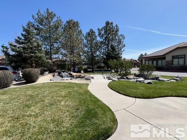 140 West Huffaker Lane, Unit 506 506 Reno, NV 89511 - Photo 12 of 15 a view of a swimming pool with a yard and plants