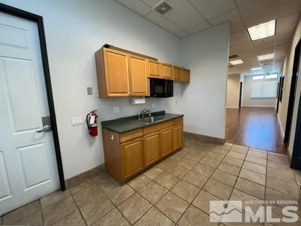 a kitchen with stainless steel appliances a refrigerator and a microwave