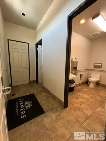 a view of a hallway with bathroom