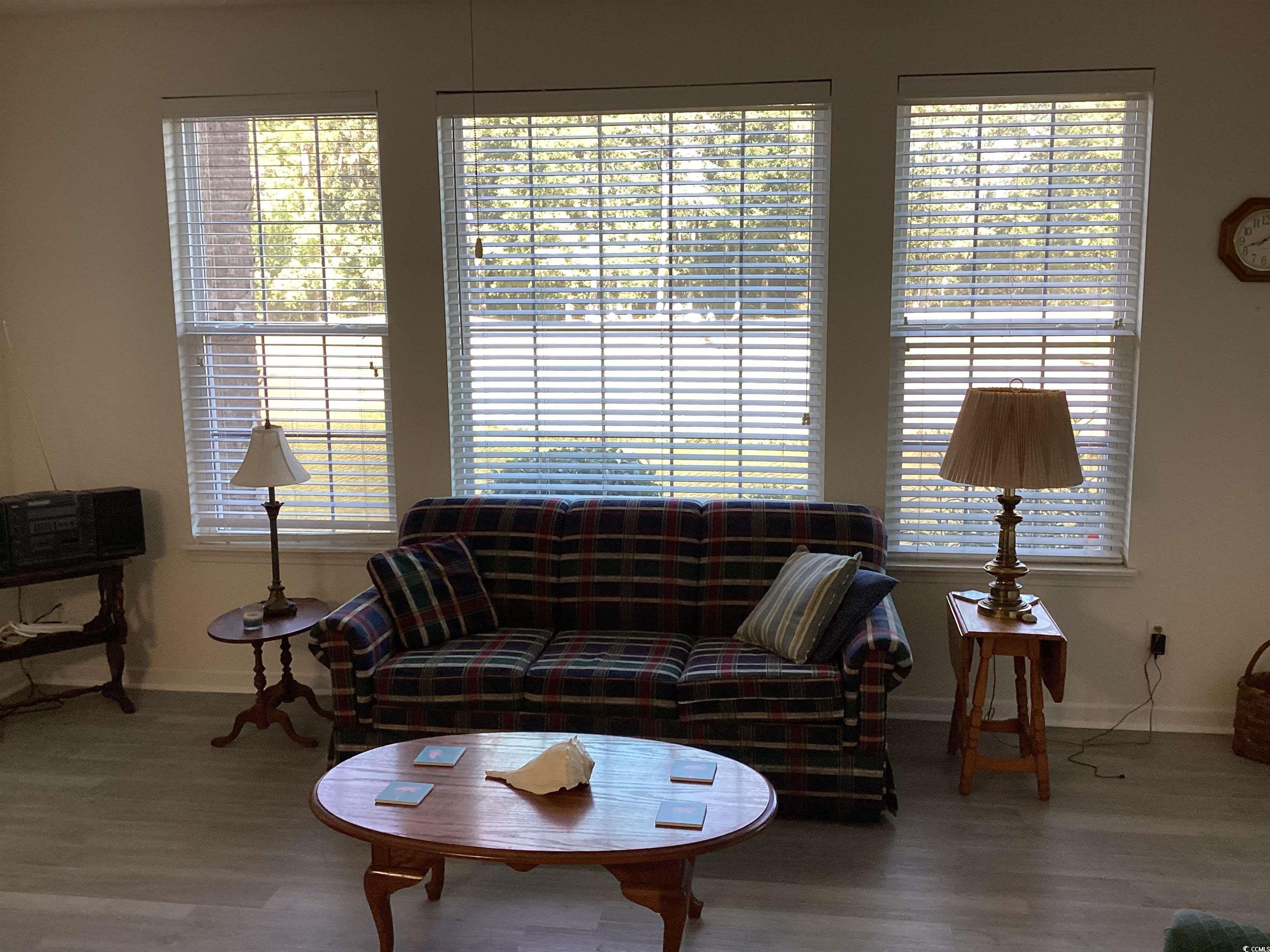 4430 Lady Banks Lane, Unit C1 Murrells Inlet, SC 29576 - Photo 13 of 34 Living room with healthy amount of natural light and wood finished floors