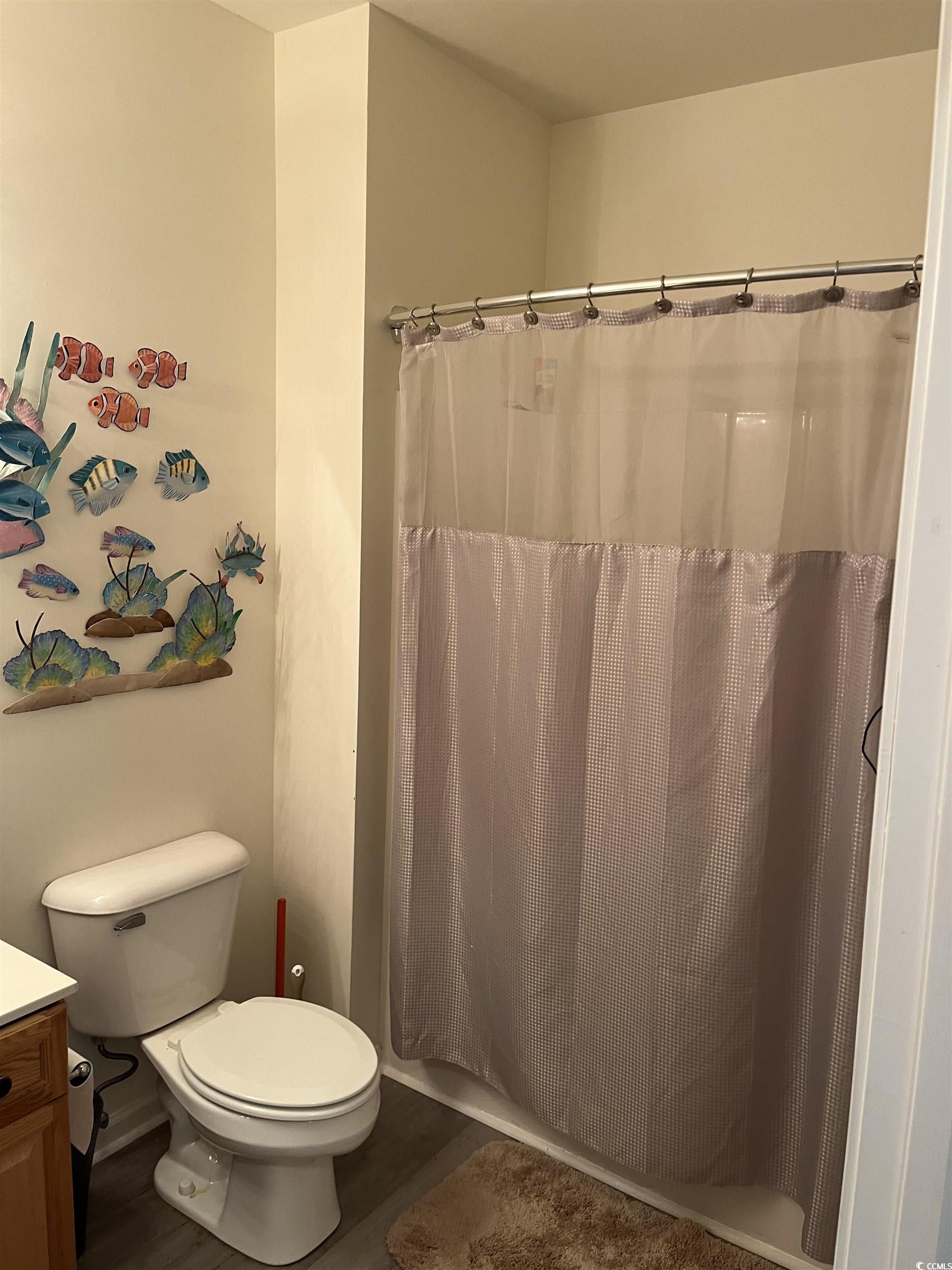 4430 Lady Banks Lane, Unit C1 Murrells Inlet, SC 29576 - Photo 18 of 34 Full bathroom with wood finished floors, vanity, and shower / bathtub combination with curtain