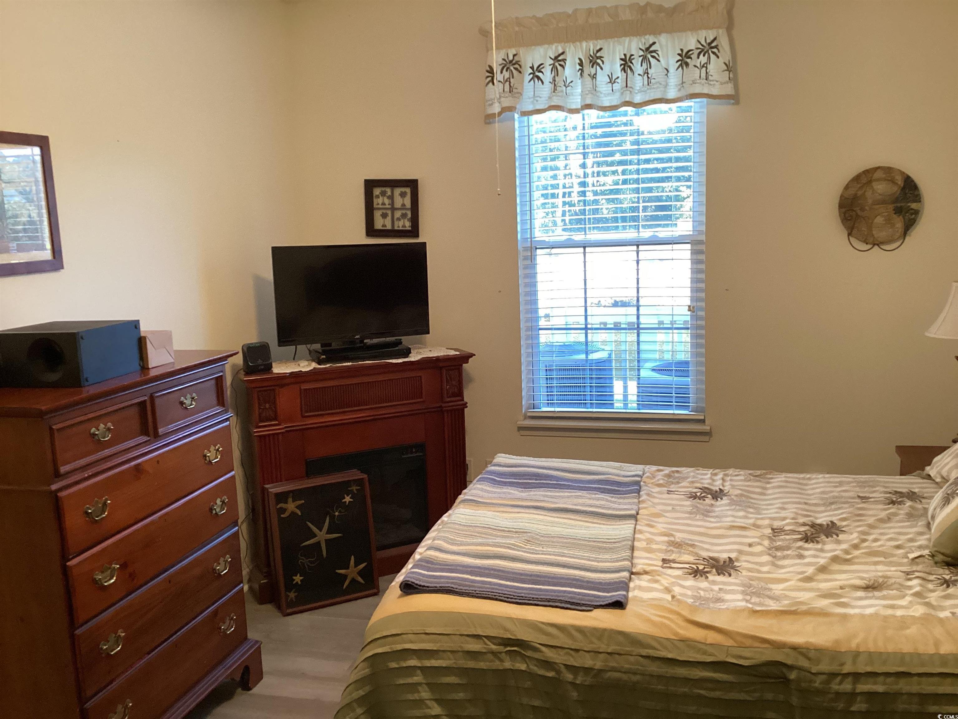 4430 Lady Banks Lane, Unit C1 Murrells Inlet, SC 29576 - Photo 19 of 34 Bedroom featuring a fireplace
