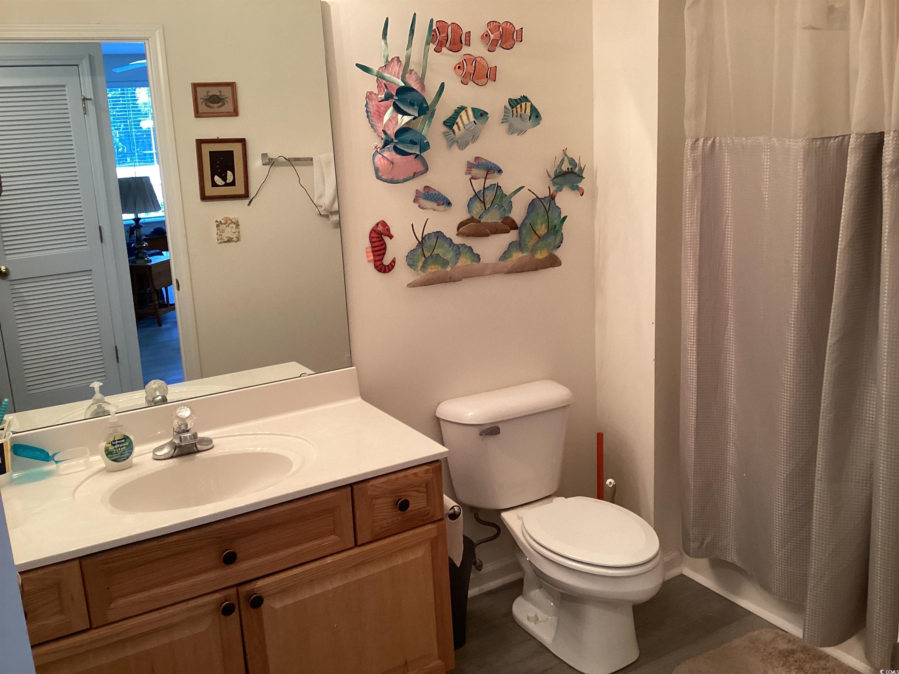 4430 Lady Banks Lane, Unit C1 Murrells Inlet, SC 29576 - Photo 22 of 34 Full bathroom with a shower with shower curtain, vanity, and dark wood finished floors