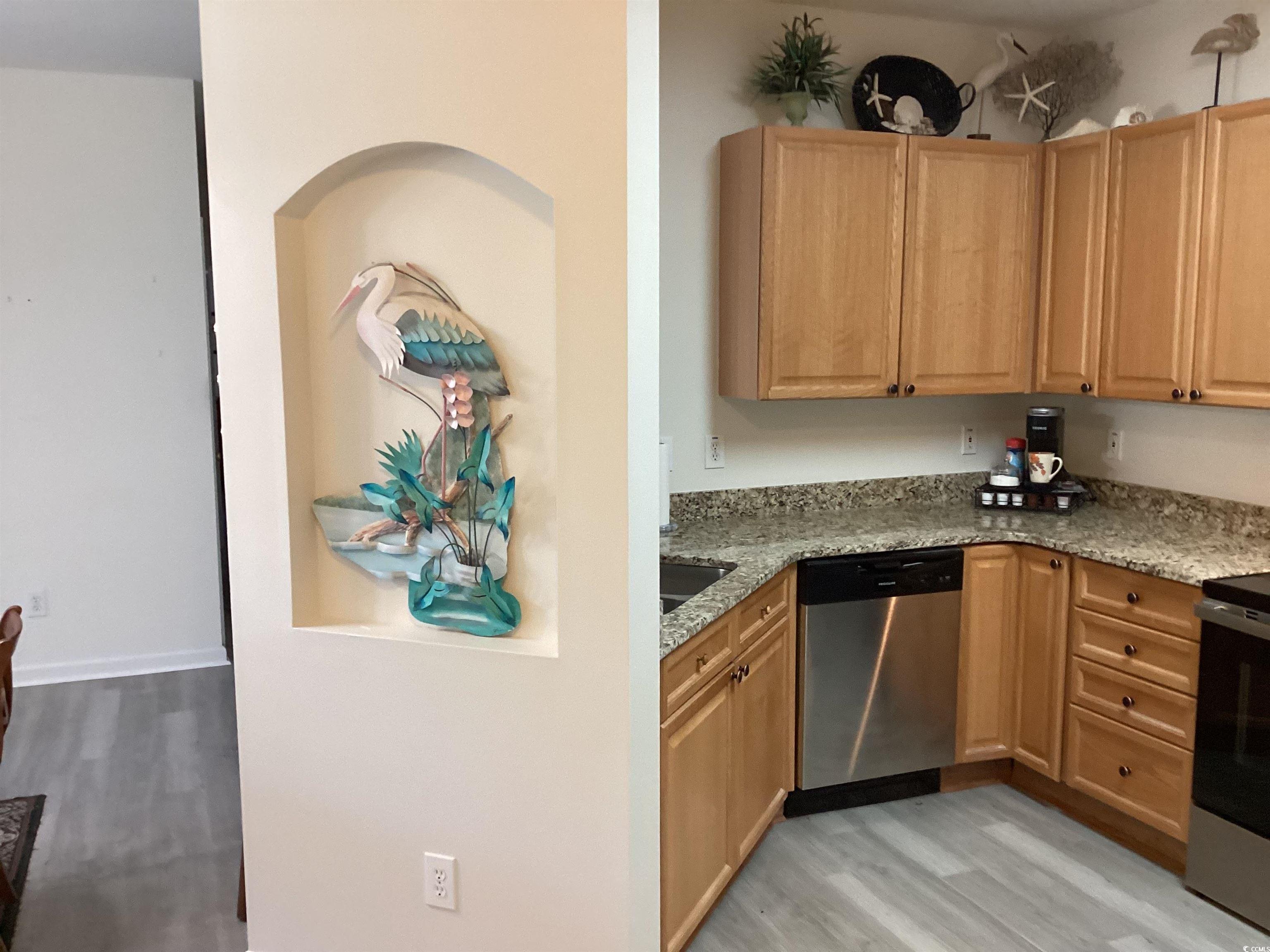 4430 Lady Banks Lane, Unit C1 Murrells Inlet, SC 29576 - Photo 4 of 34 Kitchen featuring light wood-style floors, light stone counters, and appliances with stainless steel finishes