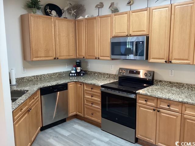4430 Lady Banks Lane, Unit C1 Murrells Inlet, SC 29576 - Photo 5 of 34 Kitchen with appliances with stainless steel finishes, light stone counters, light wood-style flooring, and light brown cabinetry