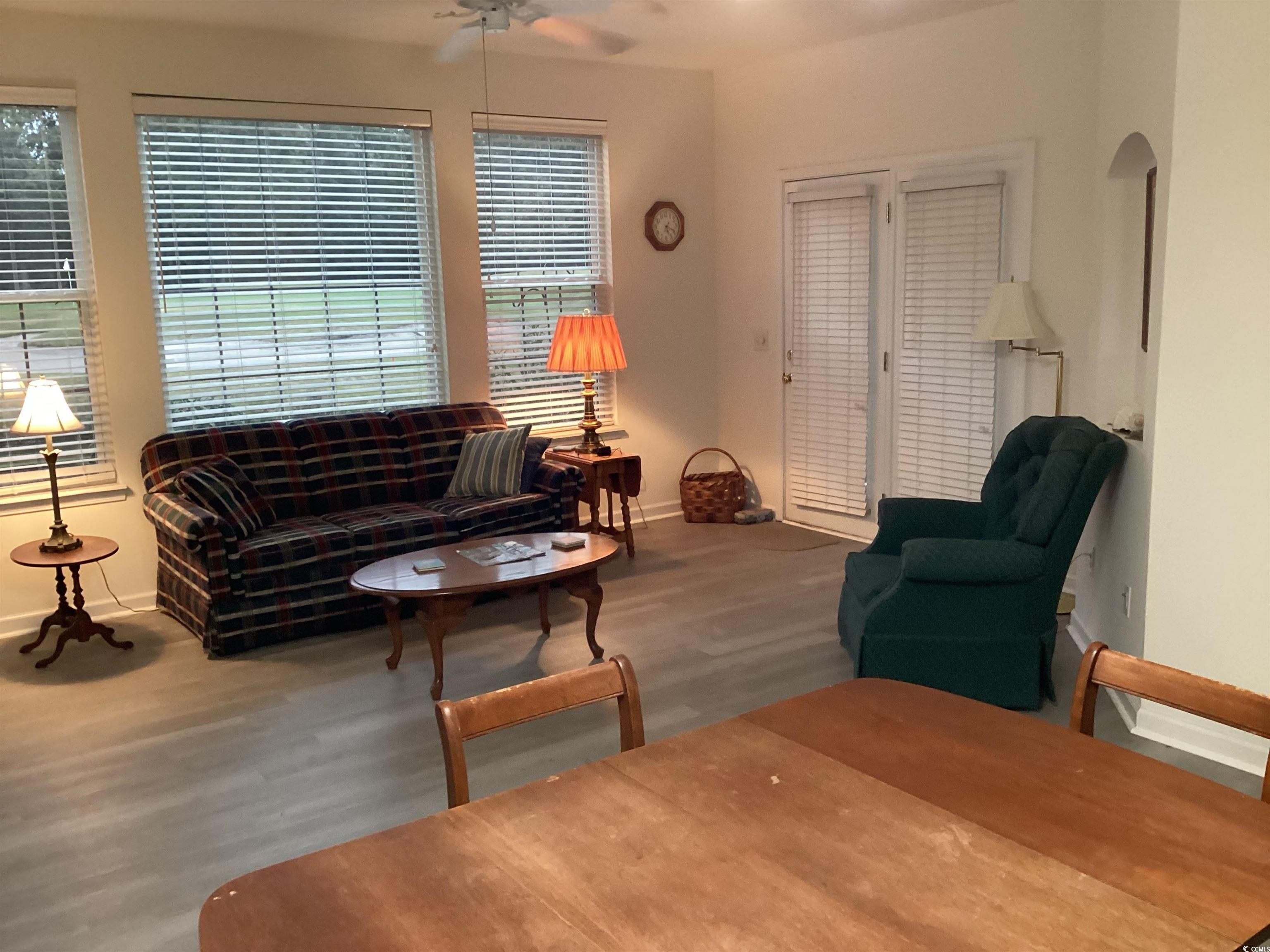 4430 Lady Banks Lane, Unit C1 Murrells Inlet, SC 29576 - Photo 10 of 34 Living area featuring wood finished floors and ceiling fan