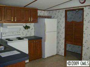 511 Maple Grove Church Road, Unit 10 Weddington, NC 28104 - Photo 6 of 7 a kitchen with a refrigerator and a stove