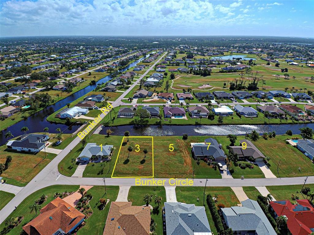 3 Bunker Circle Rotonda West, FL 33947 - Photo 3 of 5 an aerial view of a city with lots of residential buildings and ocean view in back