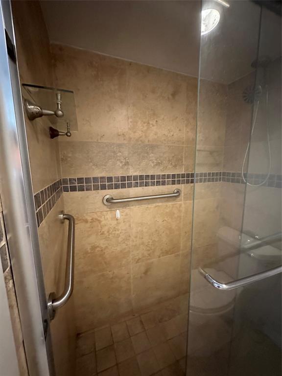 9351 Lime Bay Boulevard, Unit 102 Tamarac, FL 33321 - Photo 13 of 14 a bathroom with a shower