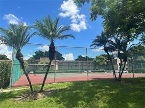 9351 Lime Bay Boulevard, Unit 102 Tamarac, FL 33321 - Photo 3 of 14 a view of swimming pool with a yard