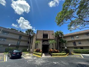 9351 Lime Bay Boulevard, Unit 102 Tamarac, FL 33321 - Photo 4 of 14 a front view of a house with garden