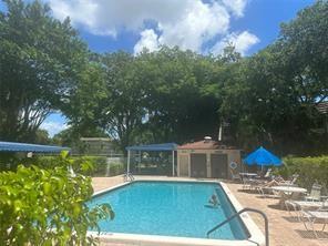 9351 Lime Bay Boulevard, Unit 102 Tamarac, FL 33321 - Photo 7 of 14 a view of a house with pool yard and sitting area