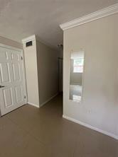 9351 Lime Bay Boulevard, Unit 102 Tamarac, FL 33321 - Photo 10 of 14 an empty room with windows