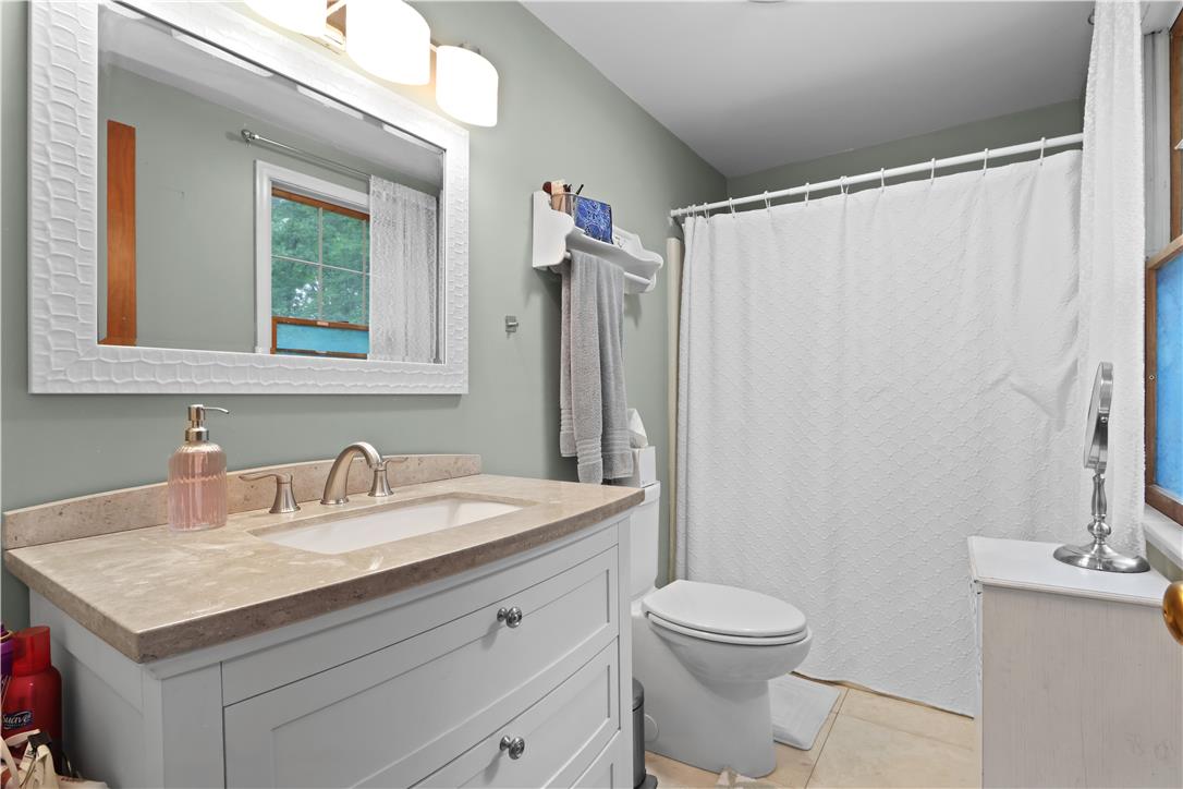 209 Remington Road East Stroudsburg, PA 18301 - Photo 27 of 41 A well-appointed bathroom features a light-colored vanity with a coordinating countertop and a large mirror.