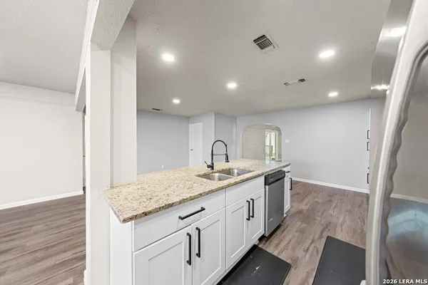 a bathroom with a granite countertop sink and a mirror