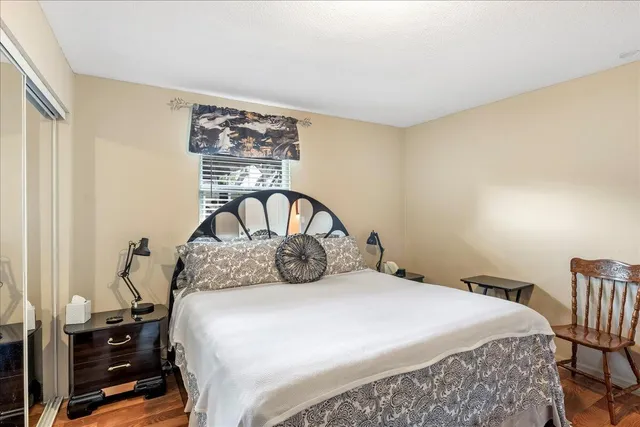 a bedroom with a bed and a table with lamp