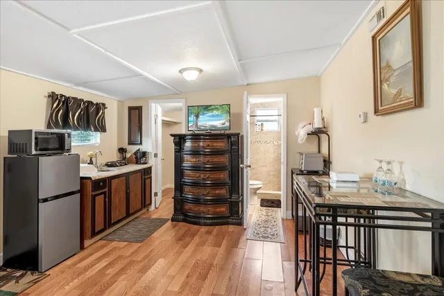 a kitchen with stainless steel appliances a refrigerator and a stove top oven
