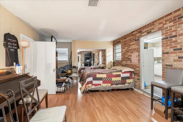 a bedroom with furniture and a wooden floor