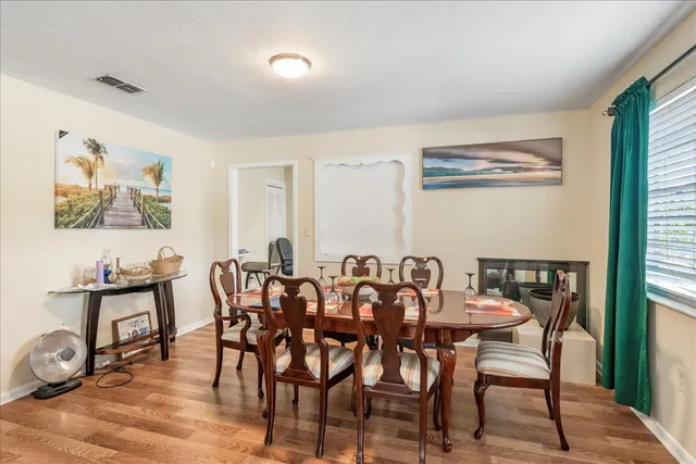 a dining room with furniture and wooden floor