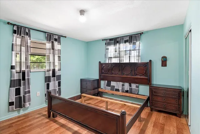 a living room with furniture a flat screen tv and a window
