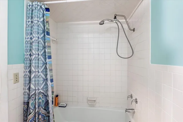 a bathroom with a shower and a shower curtain